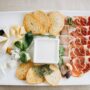 restaurant food: ham slices, cheese with nuts and crispy bread