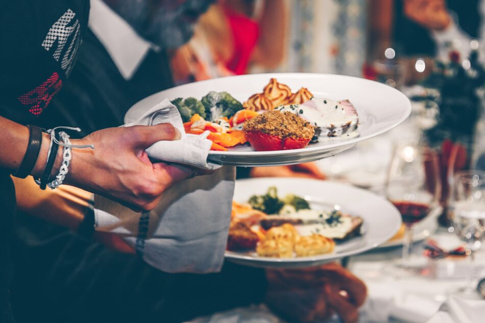 Serving food on warm plates in the restaurant.